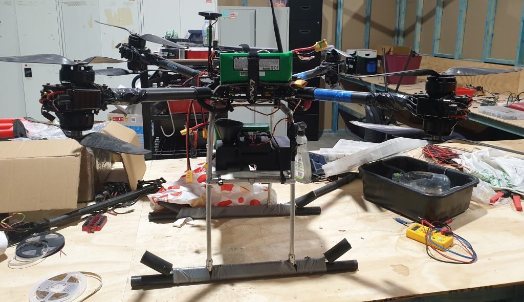 A drone fitted with an insect dispersal unit on a lab bench